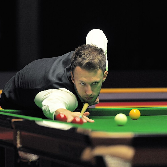 Professional snooker player aiming a precise shot on a green table during a World Open snooker match.